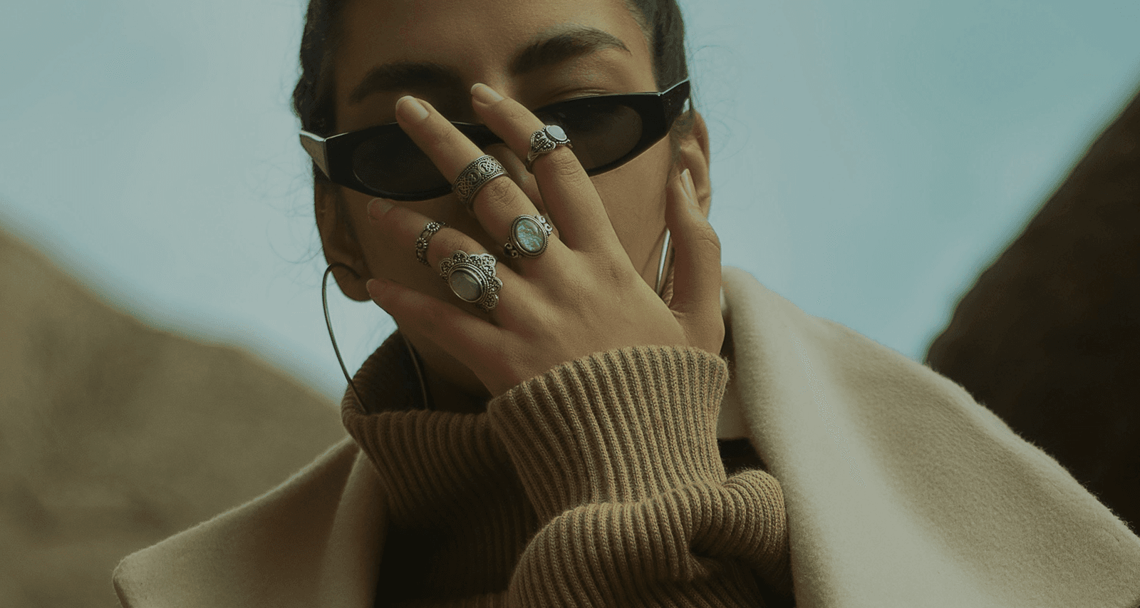 Model wearing hand-selected rings and accessories
