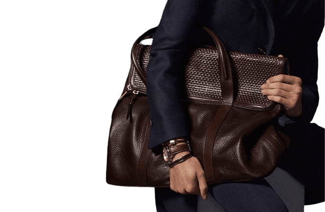 Man in a suit holding a leather bag